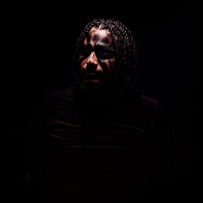 Person wearing a dark mask with a black background