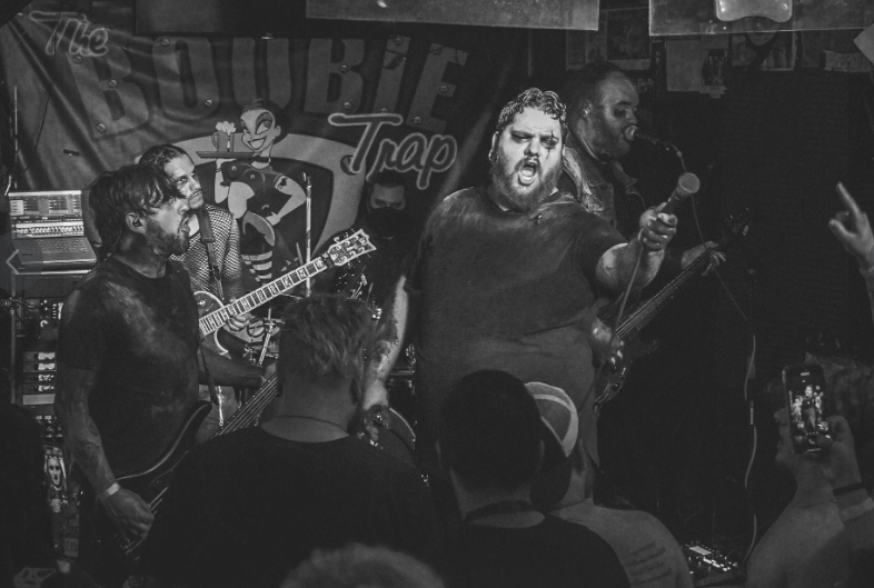 Black and white photo of the band Stories through storms performing on stage at The Boobie Trap venue.